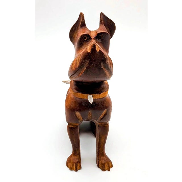 Fashioned from Teak wood, this is a diminutive figurine of a stoic and obedient dog. Even the white painted spikes on the...