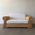Vintage 1970s pencil reed loveseat featuring a sculptural bamboo frame and newly upholstered cushions in an off-white...