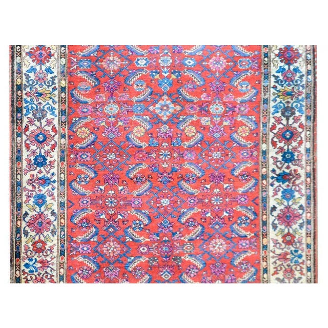 A beautiful early 20th century Persian Malayer rug with an allover trellis floral and leaf patterned field woven in pink,...