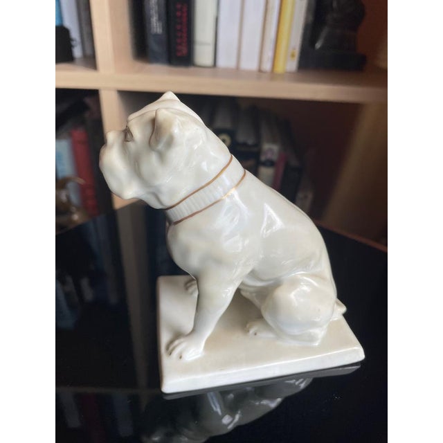 Expressive Art Deco porcelain figure "Sitting Bulldog" on a plinth with gold painting. Germany 1920s. Design: Doris Adler....