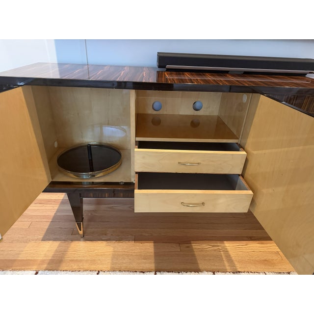 A striking Art Deco sideboard in richly figured Macassar ebony, its glossy French polish showcasing the wood's dramatic...