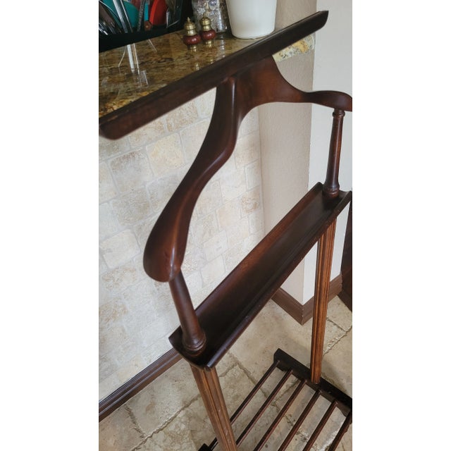 Elevate your space with the timeless utility of this vintage wooden valet stand, designed to keep garments crisp and...