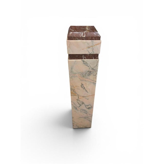 Elegant Art Deco pedestal dating from the early 20th century, crafted from two varieties of richly colored red marble. The...
