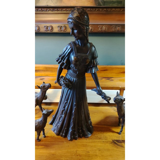 This four piece cast bronze sculpture was purchased from an estate sale in Pennsylvania. The woman stands 17.5" tall and...