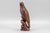 This stunning, naturalistically hand carved and brown tinted beechwood eagle figure with glass eyes, perched on a wooden...