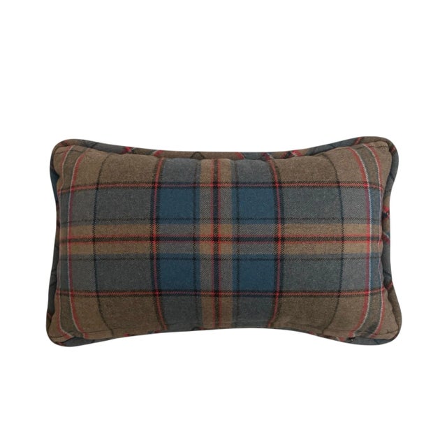 A gorgeous, 100% wool plaid lumbar pillow. Features a plaid pattern in shades of brown, red, and blue. Welt edge finish...