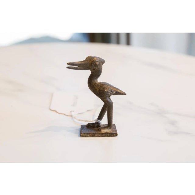:: Vintage handmade African dark bronze stork turning head. Circa mid 20th century and possibly older, this piece has such...