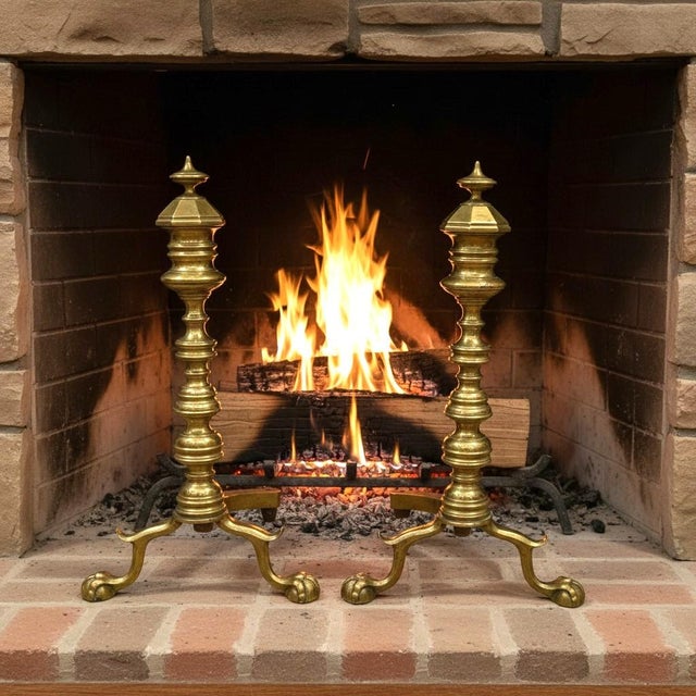 Antique brass and iron fireplace andirons, likely American, c. 1880–1920. Made during the Colonial Revival era, their tall...