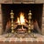 Antique brass and iron fireplace andirons, likely American, c. 1880–1920. Made during the Colonial Revival era, their tall...
