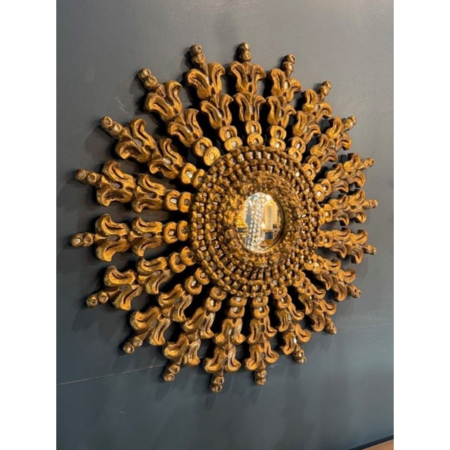 Vintage Italian carved and gilt-wood sunburst mirror. A vintage Italian carved and gilt‑wood sunburst mirror is one of the...