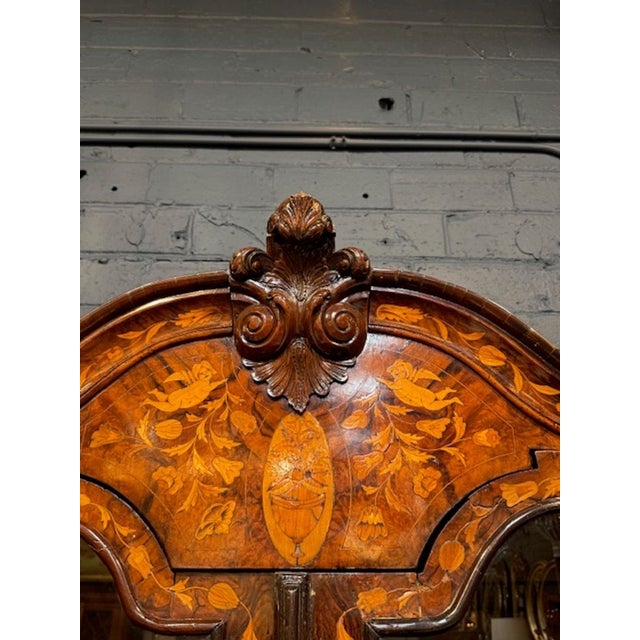 The 19th Century Dutch Marquetry Inlaid Walnut Cabinet exudes charm and style with its intricate marquetry design and rich...