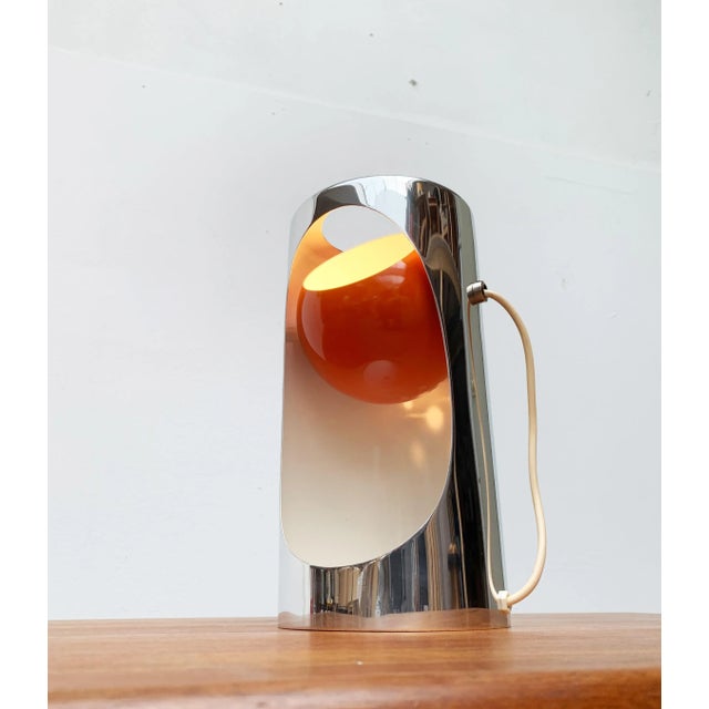 Space Age table lamp. The basic shape of the lamp is a cylinder with an inserted ball. The cylinder is open on one side...