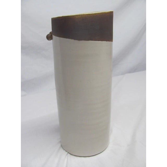 Really nice IKEBANA style vase. The vase measures 10" high with a slightly tapered top and 4" in diameter. There are two...