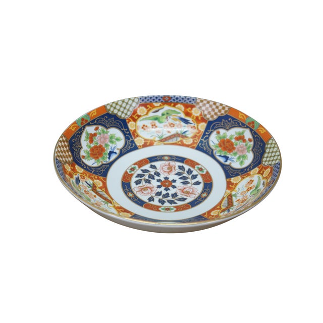 Large vintage Japanese Imari porcelain bowl featuring a traditional Imari color palette of cobalt blue, vibrant red-...