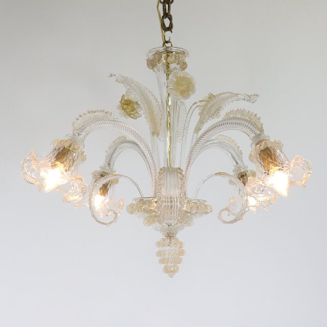 This spectacular gold-infused Cristallo Murano chandelier features four scroll arms with tri-lobed cups, elegantly styled...