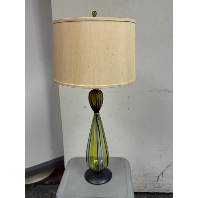 Design Plus Gallery presents a Vintage Art Glass Table Lamp. It has an elongated teardrop form body detailed in olive...
