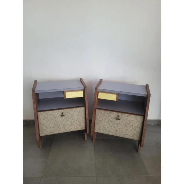 Pair of unique bedside tables with a drop-leaf and drawer, in wood and Formica veneer. Good overall condition, with...