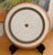 This is a vintage Heath Ceramics Sonoma chop plate, featuring a speckled off-white center framed by warm terracotta-brown...