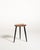 Scandinavian teak stool from the 1950s, featuring a distinctive palette-shaped seat with a circular hole and three...