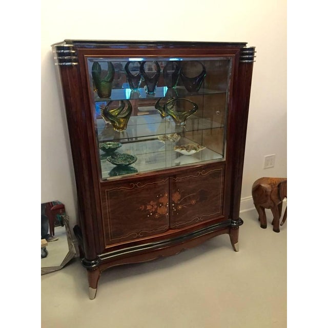 Stunning French Art Deco vitrine or dry bar. Having beautiful mother-of-pearl inlay with gorgeous marquetry. With black...