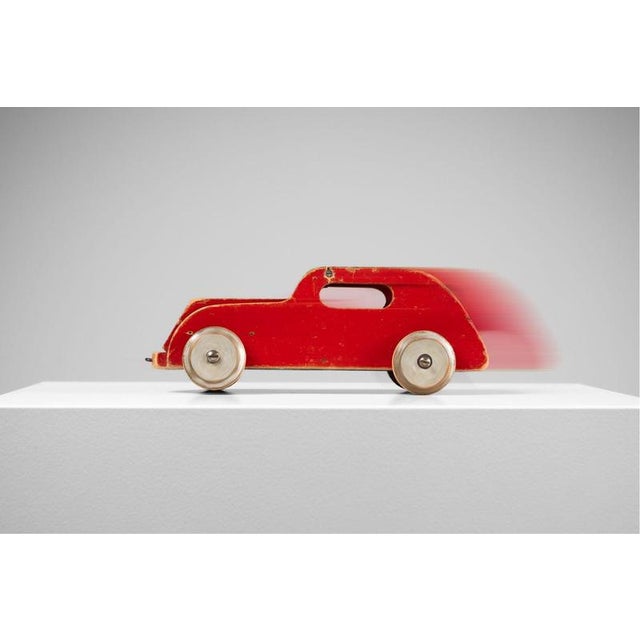 A rare model 978 wooden automobile designed by ko verzuu for ado in the netherlands, circa 1939. Its flowing, almost...