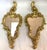 Sweet petite pair of scroll wall mirrors. They have an Art Nouveau/ Rococo cornucopia style with an antique gold painted...