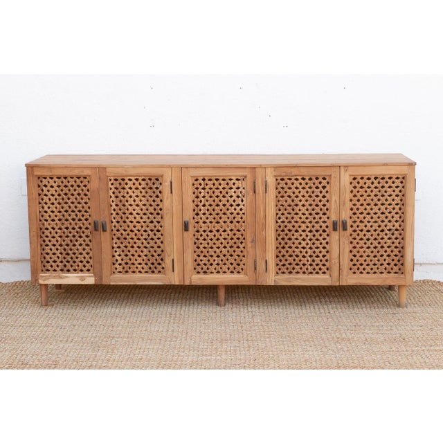 Beautiful mid-century modern style cabinet with five see-through floral carved Jali doors with metal handles. Inside the...