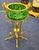 This elegant French style cachepot features a rich green porcelain finish beautifully accented with luxurious gold leaf...
