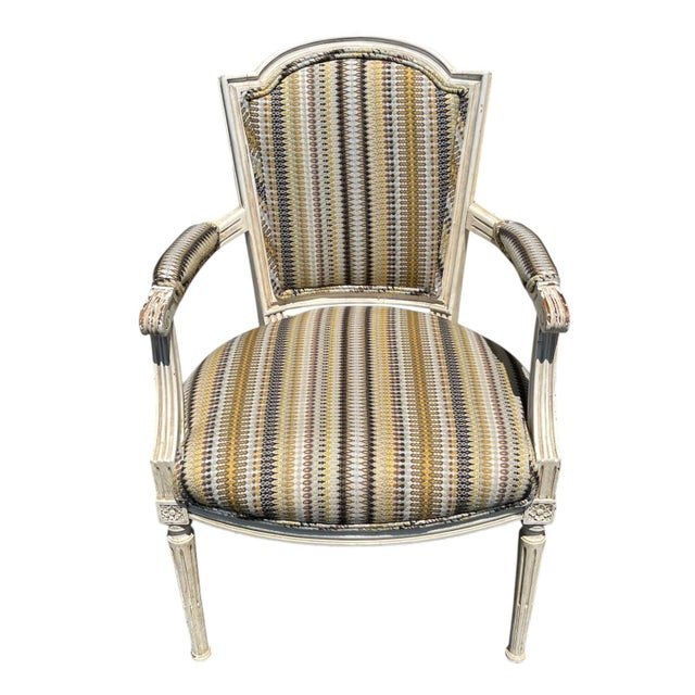 Pair of French Louis XVI style arm chairs with hand carved, painted frames. These cabriolet chairs featured a curved back...