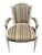 Pair of French Louis XVI style arm chairs with hand carved, painted frames. These cabriolet chairs featured a curved back...