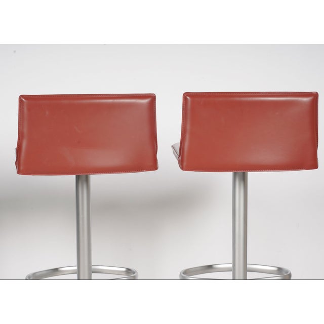 A striking set of four Bottega adjustable bar stools by Frag, designed by Renzo Fauciglietti and Graziella Bianchi....