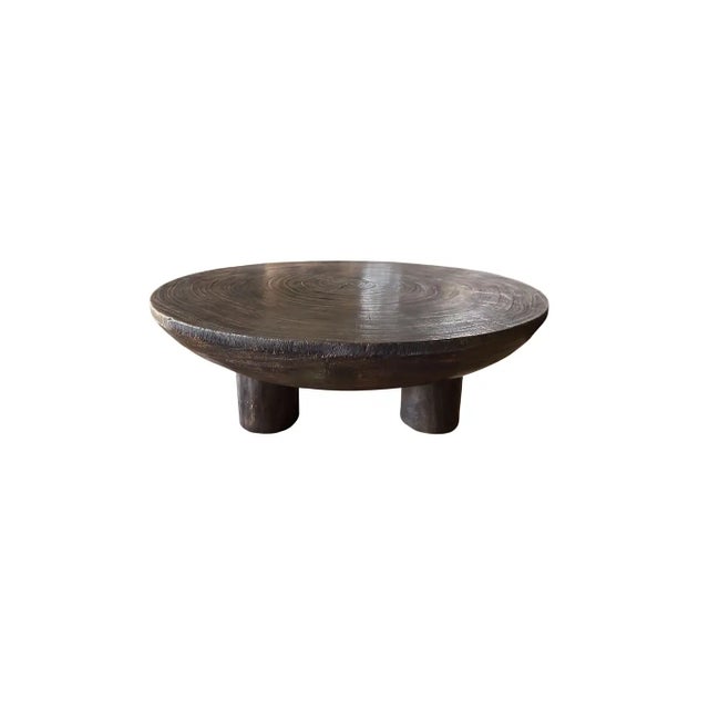 A wonderfully sculptural round table crafted from suar wood. To achieve its pigment the wood was burnt numerous times and...