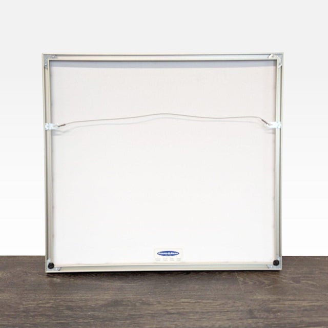 This is a delicate Japanese print featuring simple golden grass motifs on handmade paper. The print is framed behind glass...