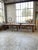 Antique farmhouse-style work table made of pine, measuring 5 meters long. Resting on six legs, including two central legs,...