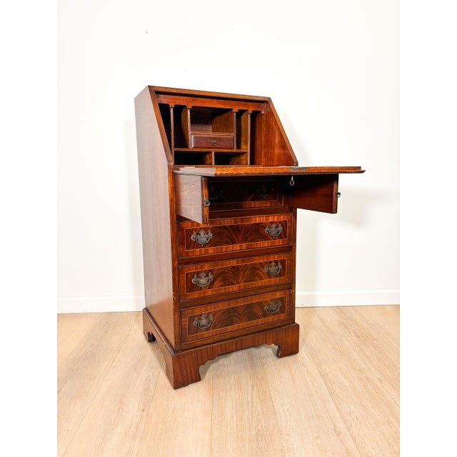 A compact secretary that brings instant warmth and character to a room. Richly figured flame mahogany and a fold away drop...