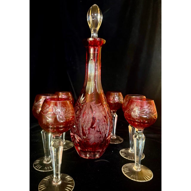 This elegant vintage small decanter set features the iconic ‘Traube’ pattern, characterized by rich cranberry colored...