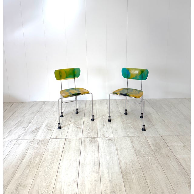 Pair of Broadway chairs, model 543. Chromed steel frame with epoxy resin seat and backrest. Spring-loaded feet with rubber...