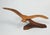 Mid 20th century handcarved Myrtlewood seagull sculpture. Sweeping gull in flight on stylized wave stand.