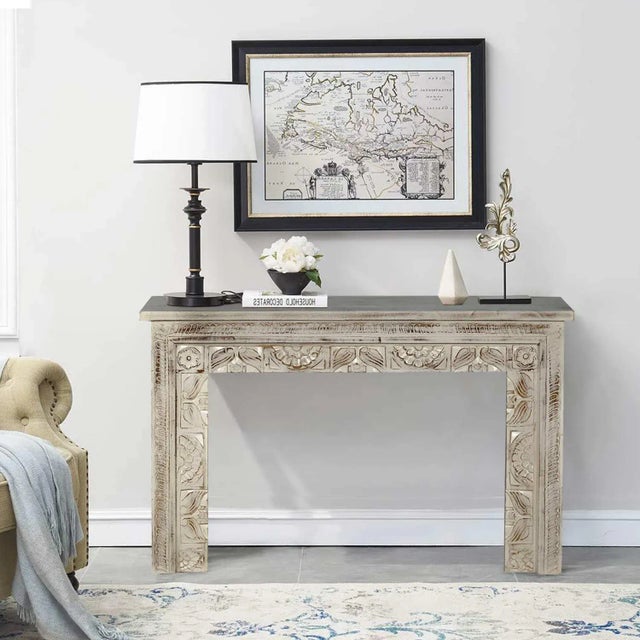 Dimensions: 47"wide X 16"deep X 30"high This hand carved console is finished in a greenish gray showing a distressed brown...