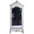 A charming French floral painted walnut armoire, C. 1880, featuring an elaborately carved architectural form and delicate...