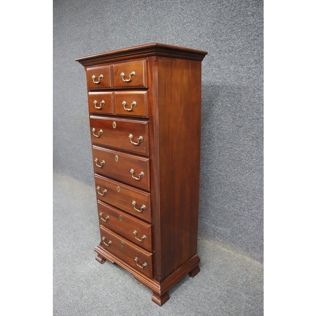 Solid cherry lingerie chest by Kincaid with classic brass hardware. Tall, narrow profile with multiple drawers for...