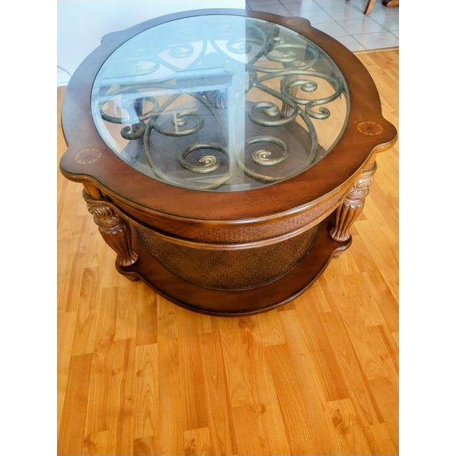 Antique wooden center side table—round, with glass and bronze ornamentation, two tiers. Coffee-brown color. This side...