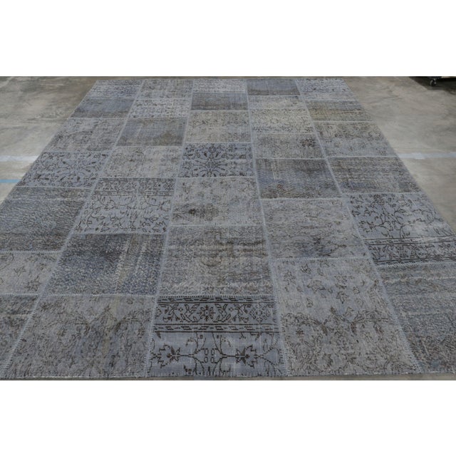 Handwoven in wool and originating from Turkey circa 1980-90, this 9x12 vintage patchwork rug is a new addition to the...