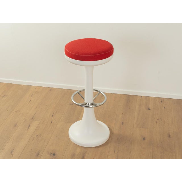 Bar stool from the 1970s by Friedrich Stukenbröker. Plastic frame with a footrest made of chrome-plated stainless steel....