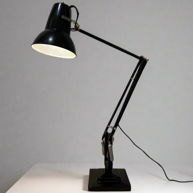 An English Art Deco anglepoise desk lamp in black enamel. Designed by George Carwardine and manufactured by Herbert Terry...