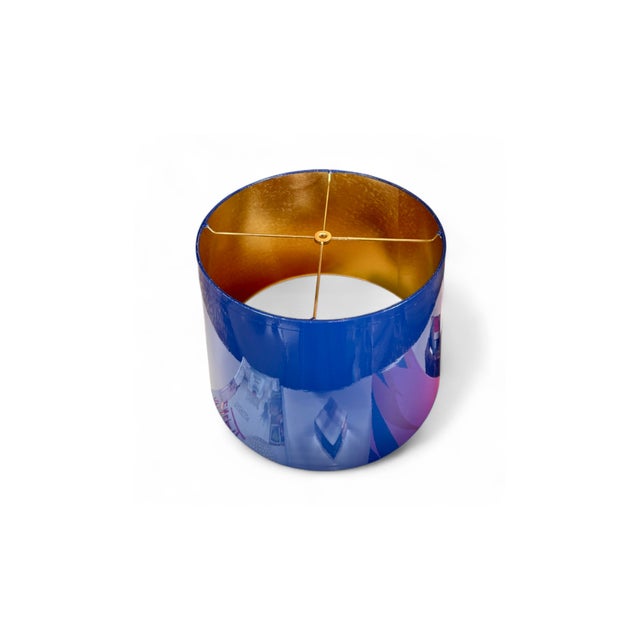 This custom hand-lacquered lampshade features a high-gloss hardback exterior and a gold ponyhair-lined interior that casts...