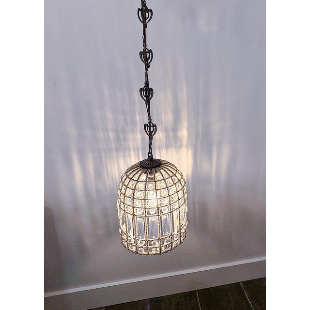 A stunning birdcage pendant light adorned with intricate details from the brand Eloquence. The cage is wrapped in stunning...