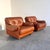 Remarks: Set mid century lounge chairs, Italy 1970s, upholstered in cognac leather. Both chairs are in very good...
