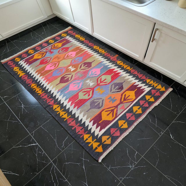 A village-made flat weave kilim from Kars, Eastern Anatolia, handmade in the 1970s from organic wool on wool with natural...