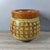 A striking Chinese carved horn cup (libation cup) featuring a rich, translucent amber-brown material with natural linear...